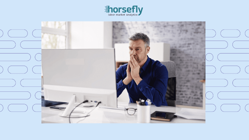Image shows a man looking thoughtful at his desk for the blog - How Talent Analytics Strengthen Your Internal Mobility Success