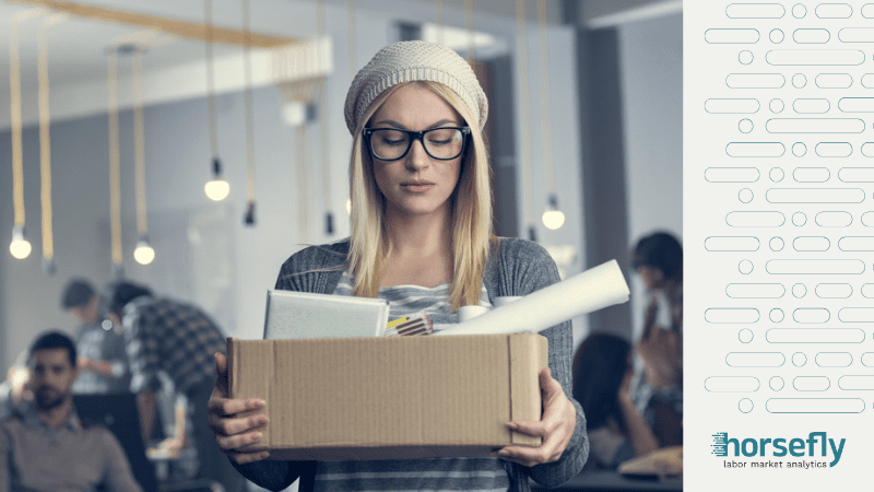 Image shows a woman holding a box of her work items for the blog - How to Bounce Back from an Unexpected Layoff