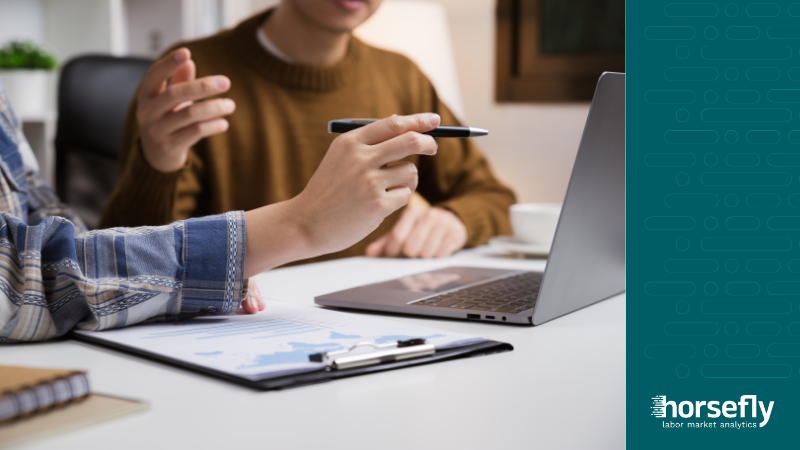 Image shows two people working on a laptop for the blog - Future-Proofing Workforce Planning with Labor Market Information Software