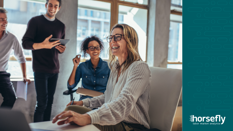 Image shows a happy team working together and planning for the blog - The Role of Talent Market Intelligence in Predictive Workforce Planning Metrics