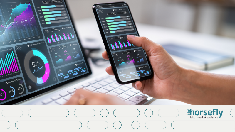 Image shows someone working on a laptop and a phone, looking at analytics for the blog - Transforming Compensation Strategies with Real-Time Market Intelligence