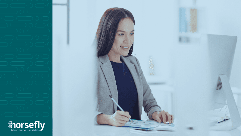 Image shows a business woman working at a computer